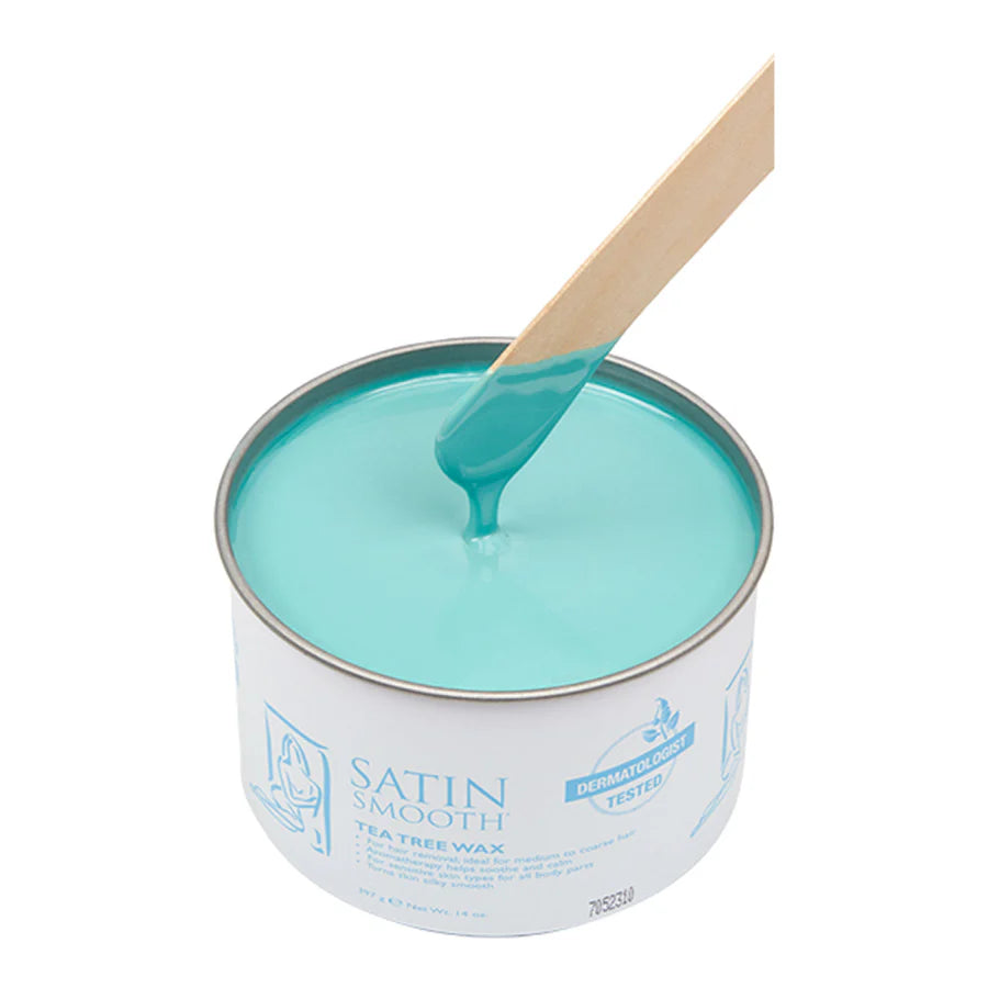 Container of satin smooth tea tree wax with a wooden applicator on a white background