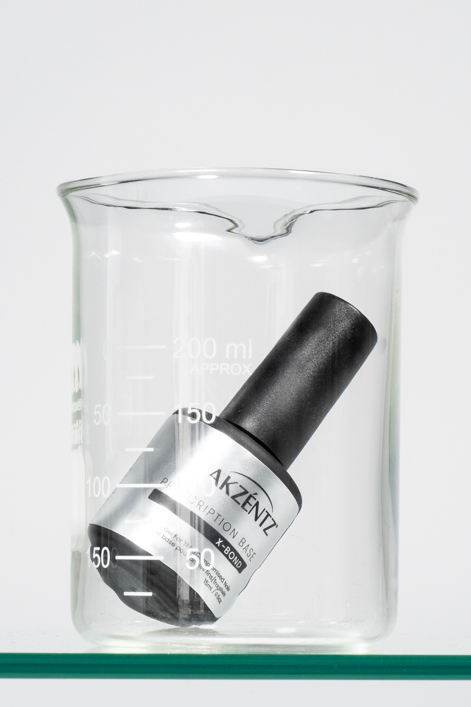 Akzentz Prescription Base X-Bond 15ml bottle in glass beaker