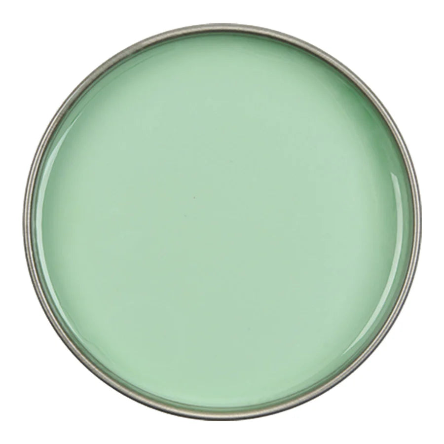 Round green ceramic plate on a white background