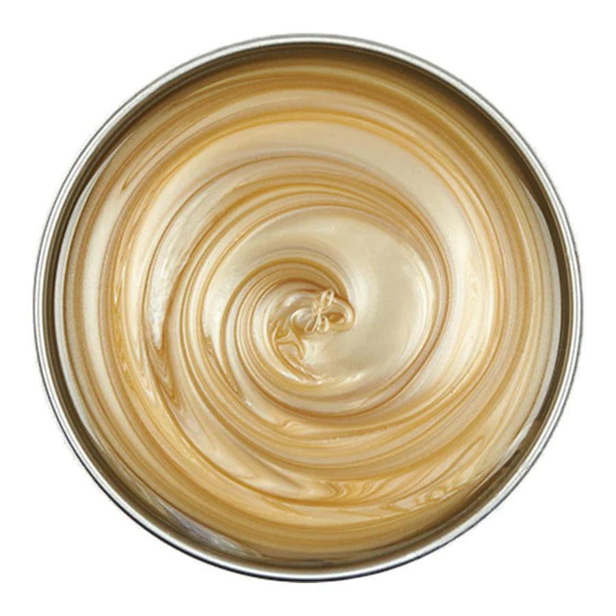 Close-up of a bowl with swirling gold and white cream