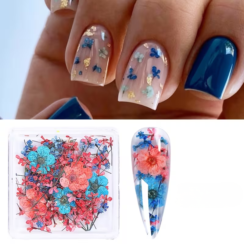 Nail art with floral decorations and a box of flowers on a white background