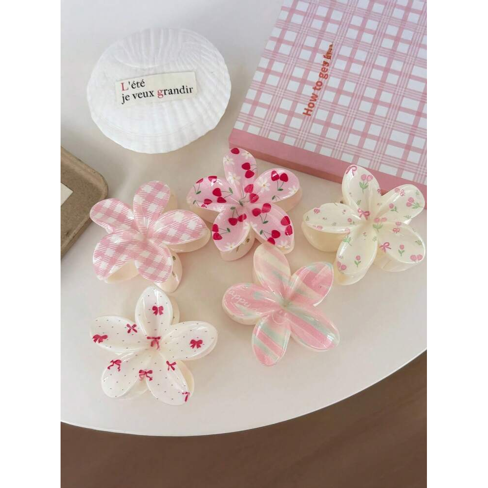 Five Coconoir Beauty assorted patterned flower hair claw clips arranged in pink and cream designs