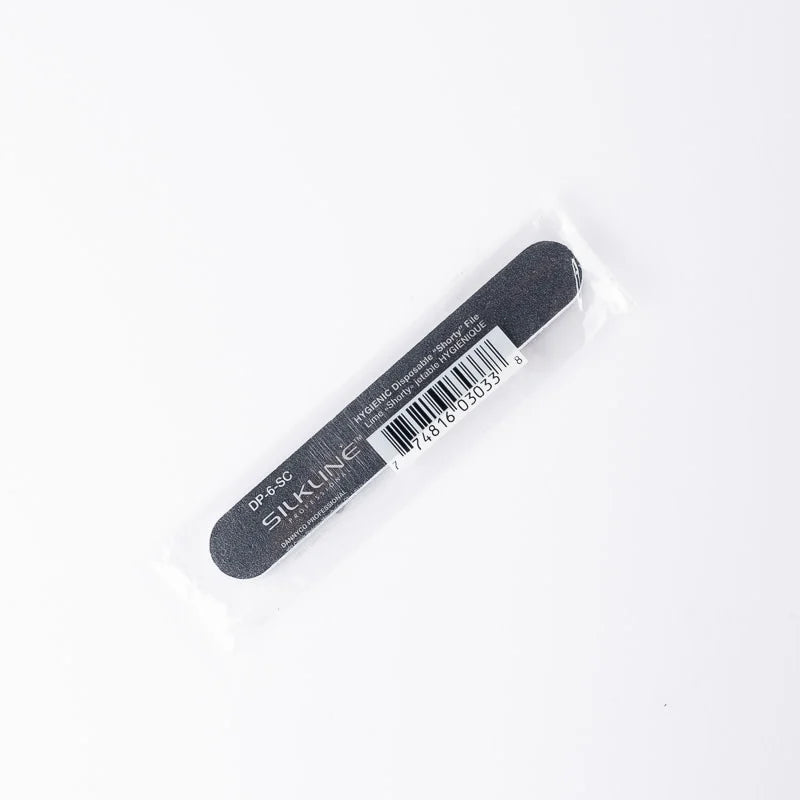 A black nail file with white text reading 'STAINLINE' and a barcode, sealed in a clear plastic sleeve on a white background.