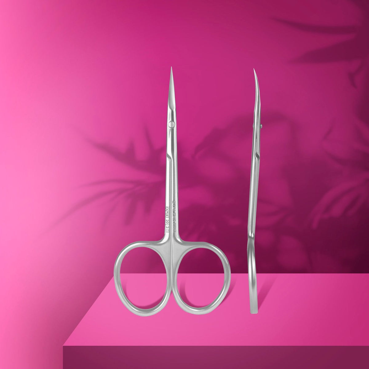 Staleks Expert curved cuticle scissors displayed on a magenta product graphic.