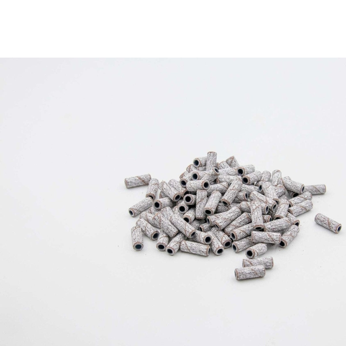 U-Tools Mini White 100-grit sanding bands, 3 x 12.7 mm, loose bands on a white background.