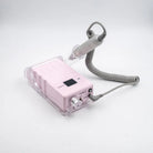 A pink electronic beauty device with a clear protective cover, a gray coiled cord, and a handheld wand applicator, shown on a white background.