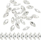 Clear faceted marquise-shaped rhinestones scattered on a white background, with a row of the same stones aligned along the bottom edge.