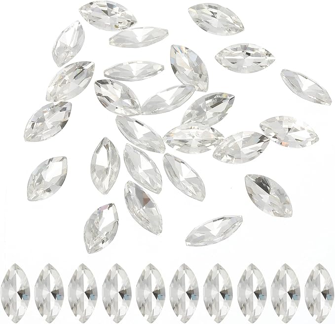 Clear faceted marquise-shaped rhinestones scattered on a white background, with a row of the same stones aligned along the bottom edge.