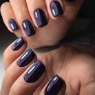 Glossy deep purple manicure created with Akzentz Luxio Abyss
