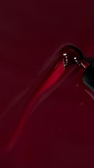 Akzentz Luxio Cassis deep blackcurrant-burgundy gel polish brush close-up