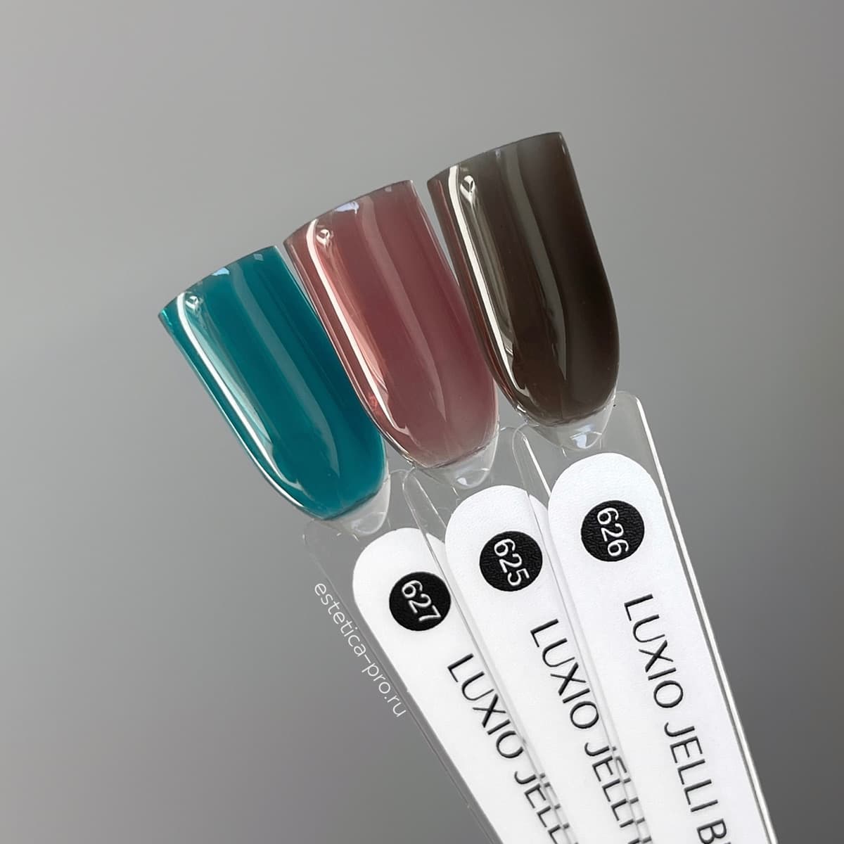 Akzentz Luxio Jelli Teal gel color shown with related shades on swatch sticks