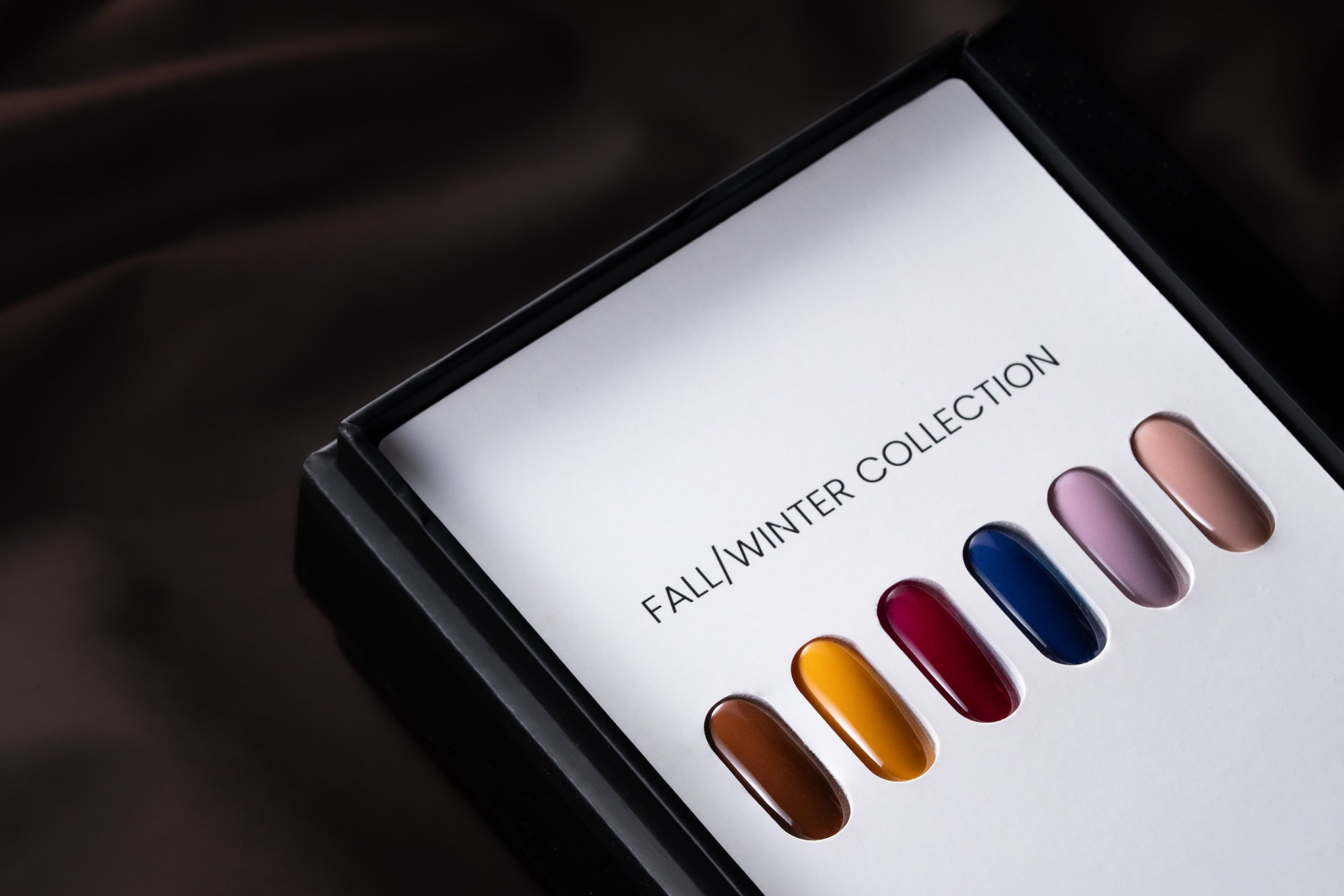 Akzentz Luxio Echo Fall/Winter Collection display with six gel polish color swatches