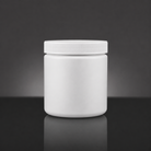 A blank white plastic jar with a ribbed screw-on lid, centered on a reflective dark gray surface against a dark gray gradient background.