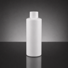 A blank white plastic bottle with a matching screw cap, standing upright on a dark reflective surface against a dark gray gradient background.