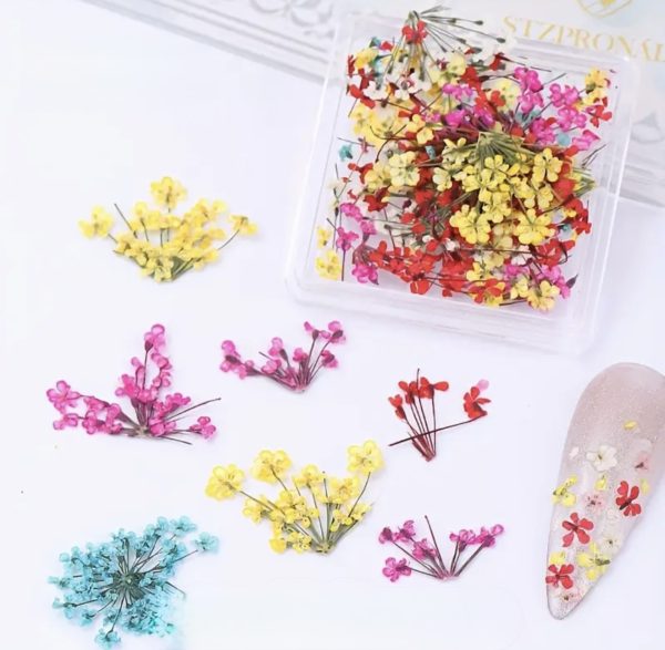 Clear resin phone case with pressed flowers on a textured white surface