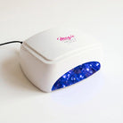 White nail dryer with blue light on a white background