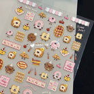 A sheet of cute pastel-themed stickers featuring cartoon characters and food items like donuts, cupcakes, cookies, and strawberries, displayed on a dark surface next to a black card labeled 'Sweet Baby!'.