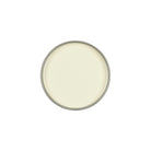 A round, top-down view of a light cream or off-white paint can against a solid white background.
