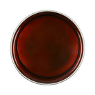 Round brown object with a metallic rim on a white background