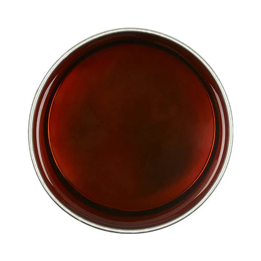 Round brown object with a metallic rim on a white background