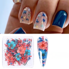 Nail art with floral decorations and a box of flowers on a white background