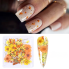 Nail art with floral decorations and a box of flowers on a white background