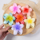 Coconoir Beauty Small Island Flower hair claw clips in assorted colors displayed on a round tray