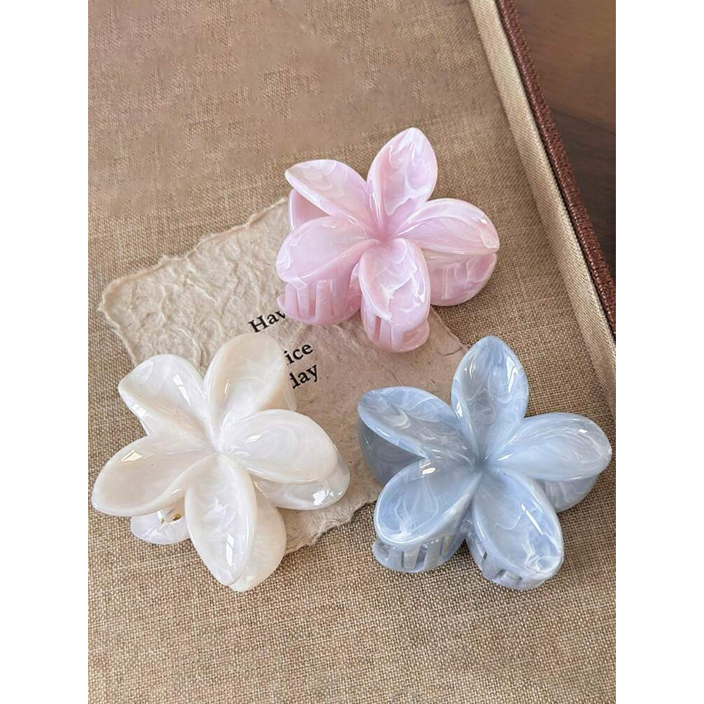 Coconoir Beauty blue, pink, and white flower hair claw clips displayed together