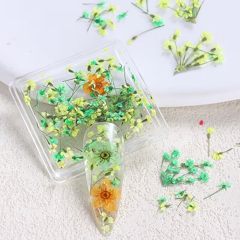Clear resin phone case with pressed flowers on a textured white surface