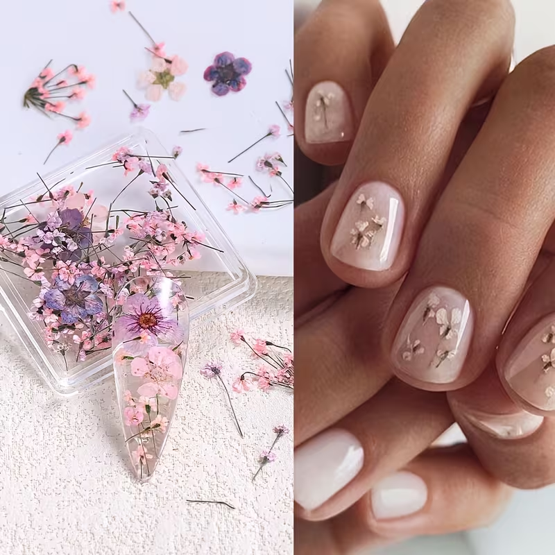Clear resin phone case with pressed flowers on a textured white surface