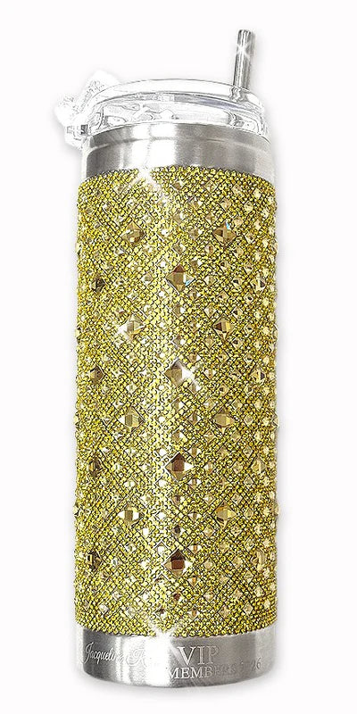 Gold glittery tumbler with silver accents on a white background