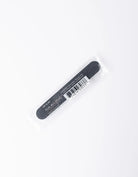 A black nail file with white text reading 'STAINLINE' and a barcode, sealed in a clear plastic sleeve on a white background.