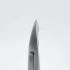 Close-up of a metallic surgical instrument tip, likely a biopsy forceps or similar medical tool, shown vertically against a clean light gray background.