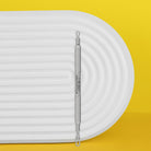 Staleks Expert 30 Type 1 double-ended loop extractor on a white tray with yellow background