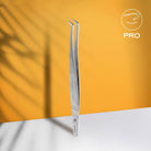 Staleks Volume Crane eyelash tweezers displayed on an orange promotional graphic.