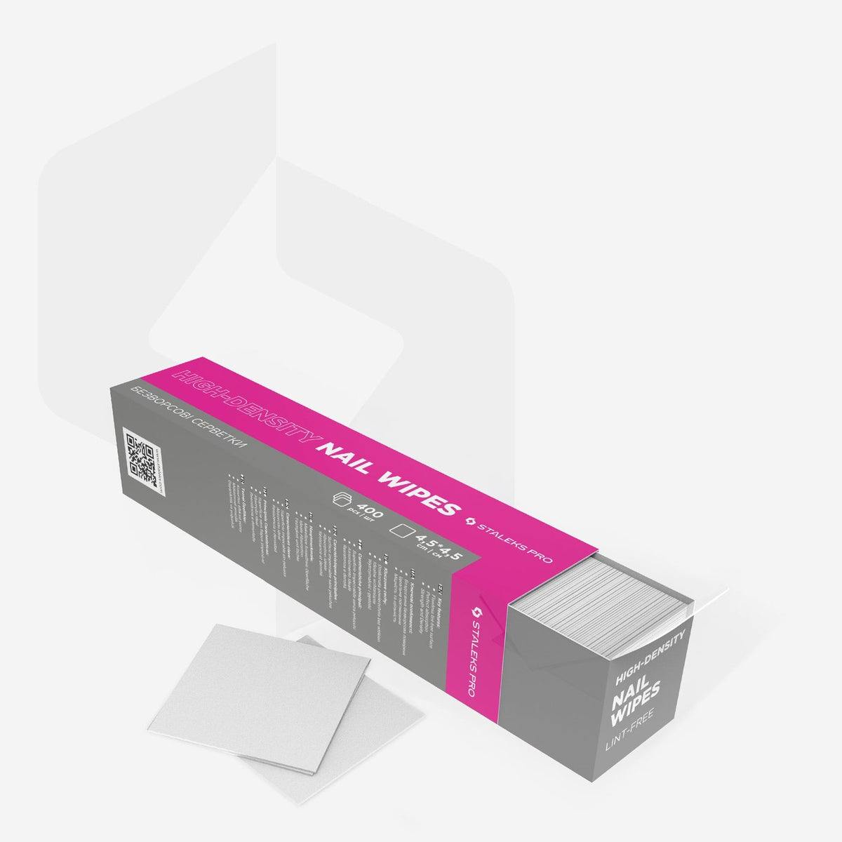 Open Staleks lint-free nail wipes box with stacked wipes inside and loose squares beside it.