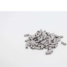 U-Tools Mini White 100-grit sanding bands, 3 x 12.7 mm, loose bands on a white background.