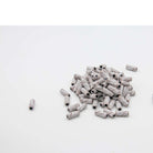 U-Tools Mini White coarse 80-grit sanding bands, 3 x 12.7 mm, loose bands on a white background.